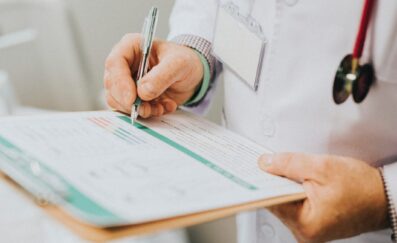 doctor writing something on clipboard